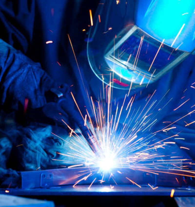 Welder erecting technical steel. Industrial steel welder in factory technical